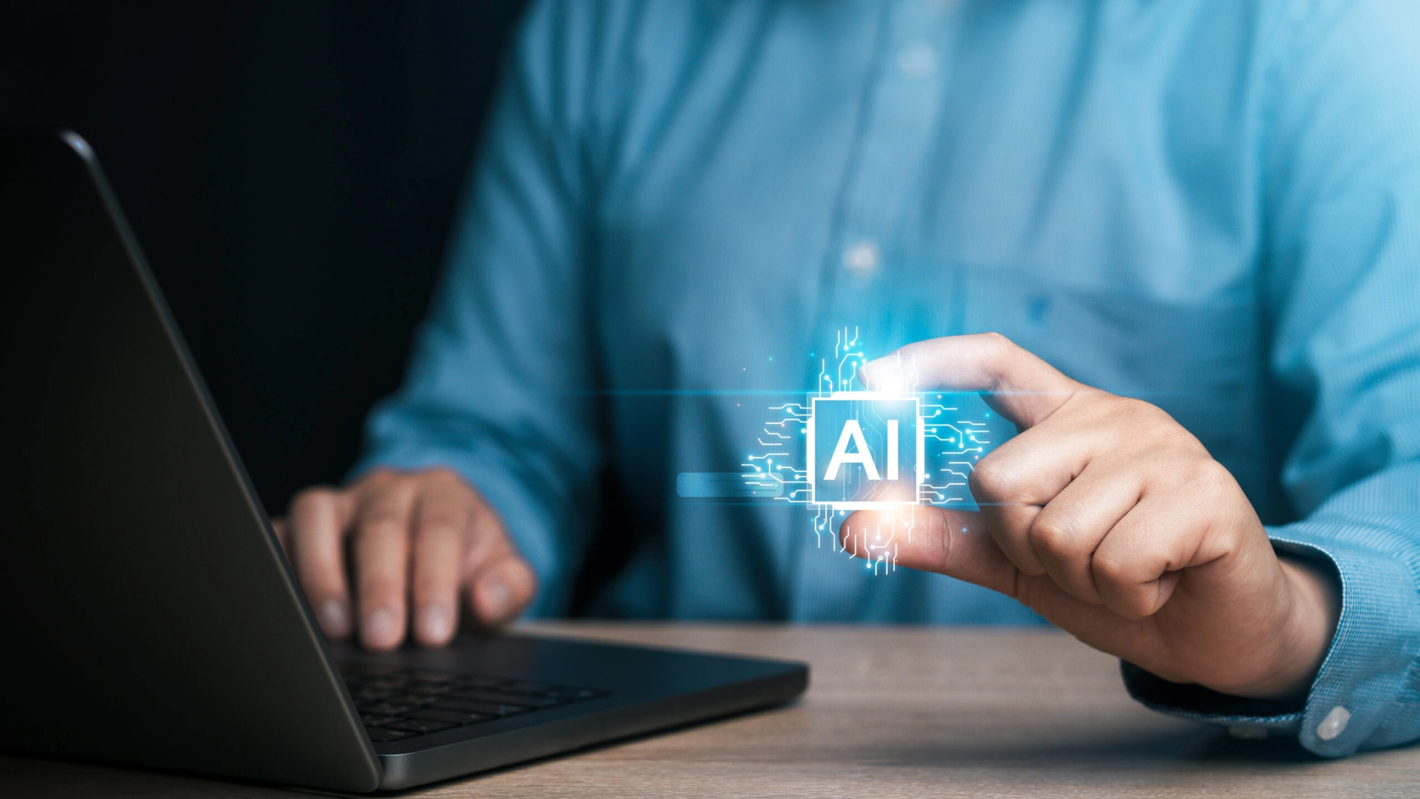 A man focused on a laptop displaying a vibrant digital AI interface, showcasing technology in action.