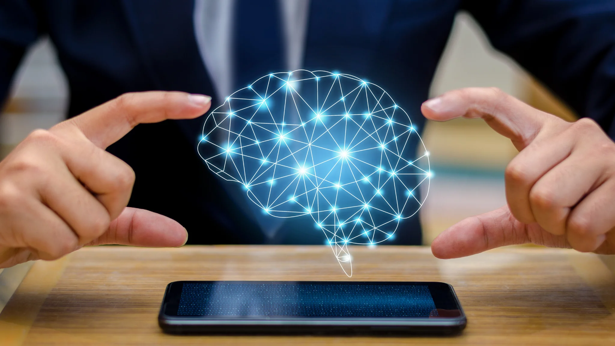 Businessman holding a smartphone displaying a brain concept, symbolizing innovation and technology in business.