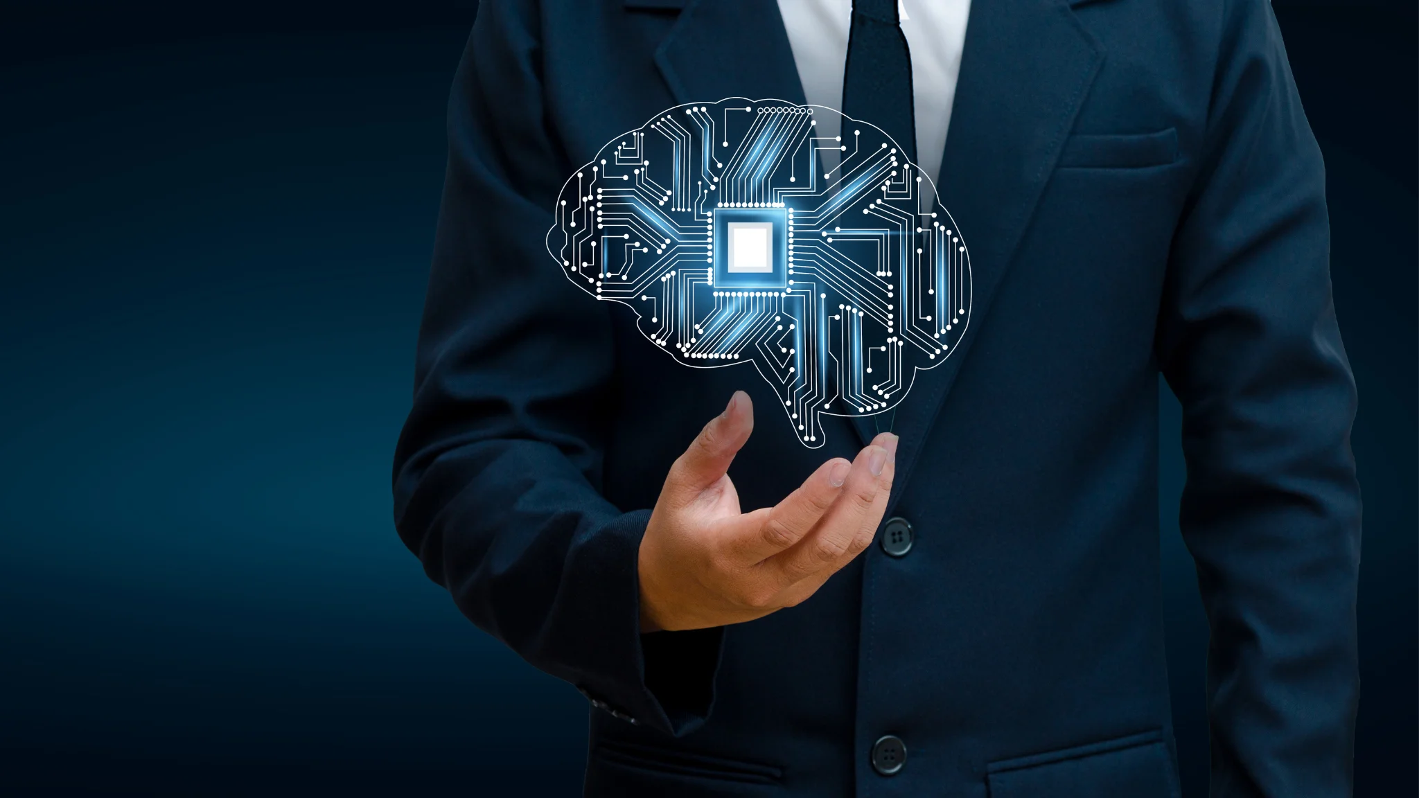 A man in a suit holds a brain integrated with a circuit board, symbolizing the fusion of technology and intelligence.