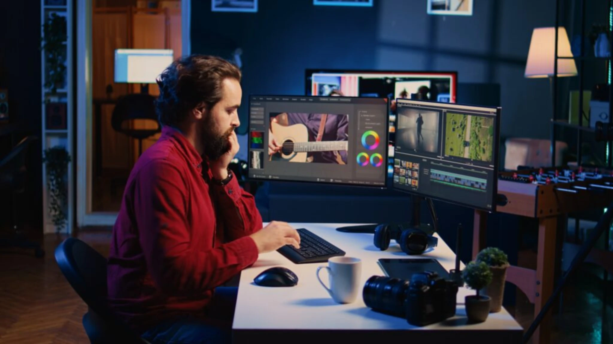 A man sits at a desk, focused on multiple computer monitors displaying various tasks and information.
