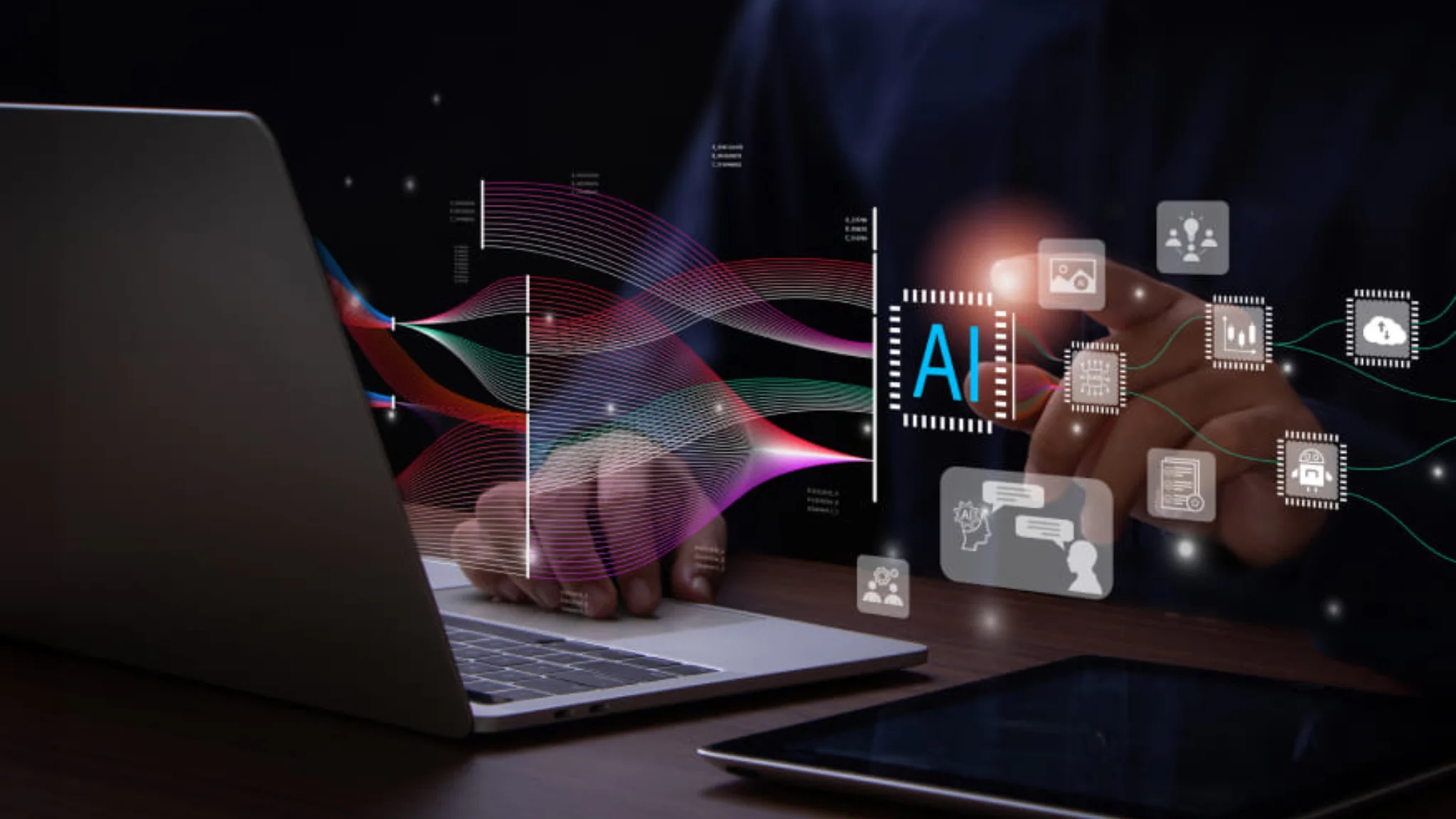 A man focused on a laptop, interacting with a colorful digital interface on the screen.