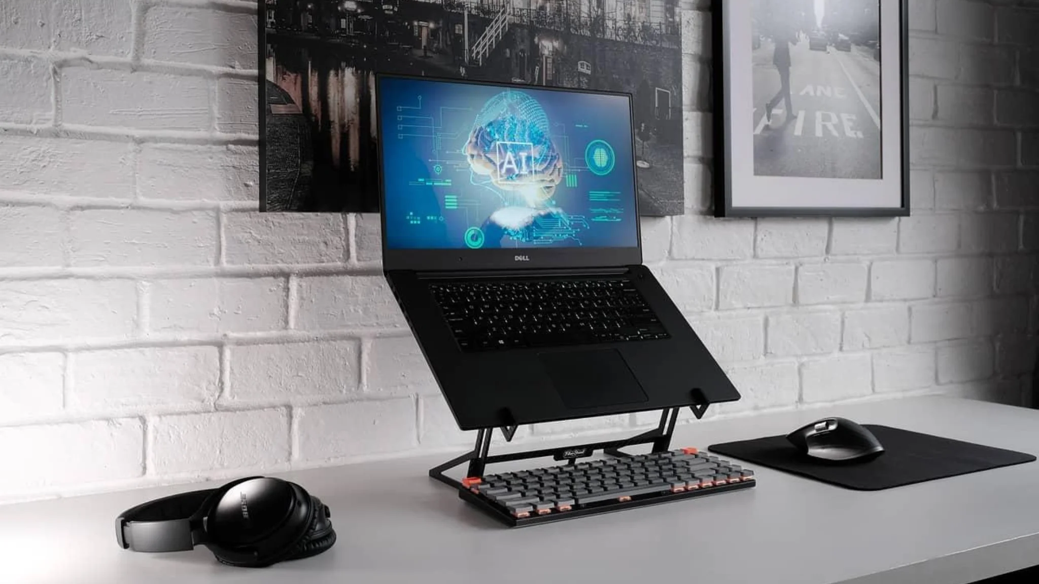 A laptop sits on a desk alongside a mouse and keyboard, creating a tidy workspace for productivity.
