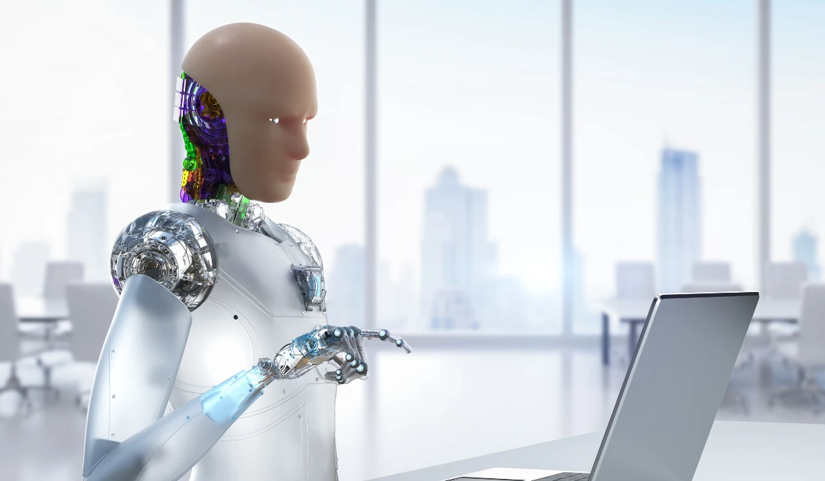 A robot working diligently on a laptop, blending technology and productivity in an office environment.