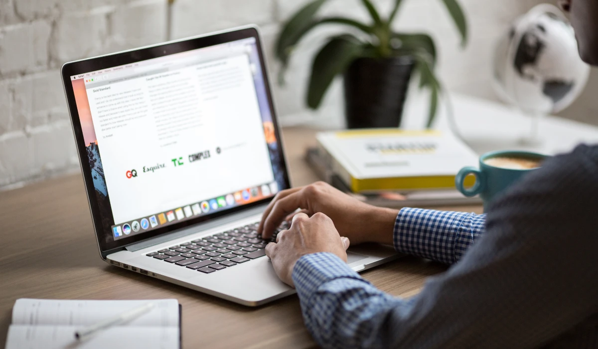 Someone engaged in typing on a laptop, concentrating on the screen in front of them.