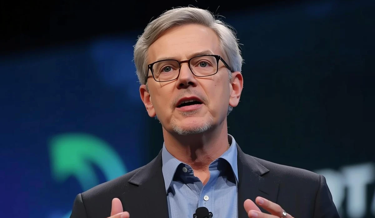 A man in glasses delivers a talk at a conference, capturing the attention of attendees with his engaging presentation.