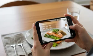Phone displaying food nutrition facts over salmon meal